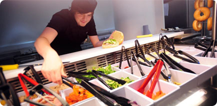 man serving food in a canteen